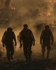 The Black: a fire crew walking up out of the smoke.